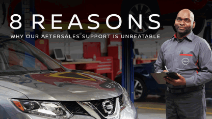 Aftersales agent in workshop with clipboard in fron of a car