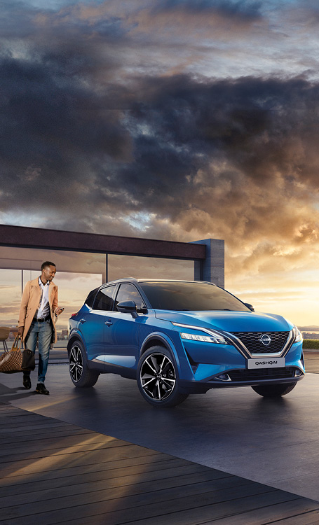 Blue Qashqai in front of building with driver approaching