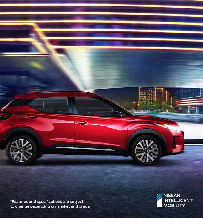 Nissan Kicks driving past building