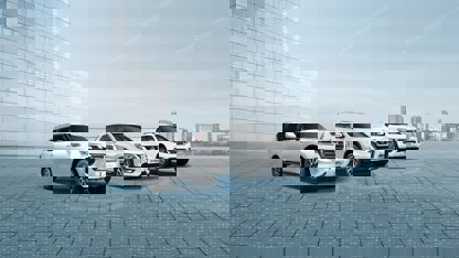 White Qashqai, Patrol and Navara in front of a building
