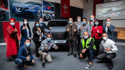 Group of Nissan employees at a Navara giving a thumbs up