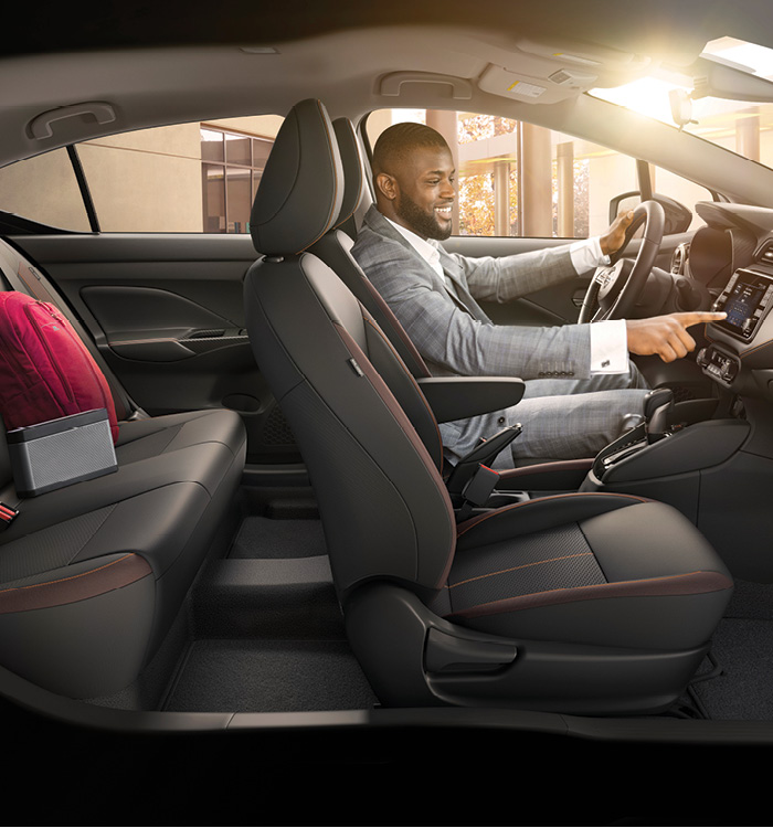 Interior side view of Nissan Sunny with man in driver seat